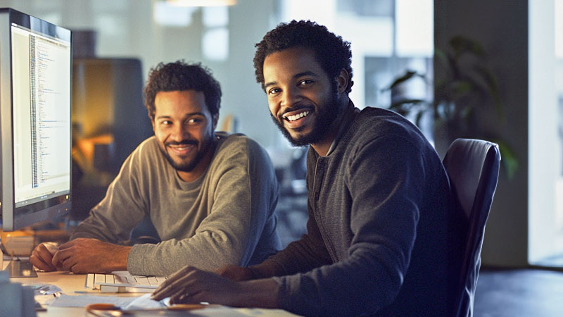 Tech developers working at a table. 