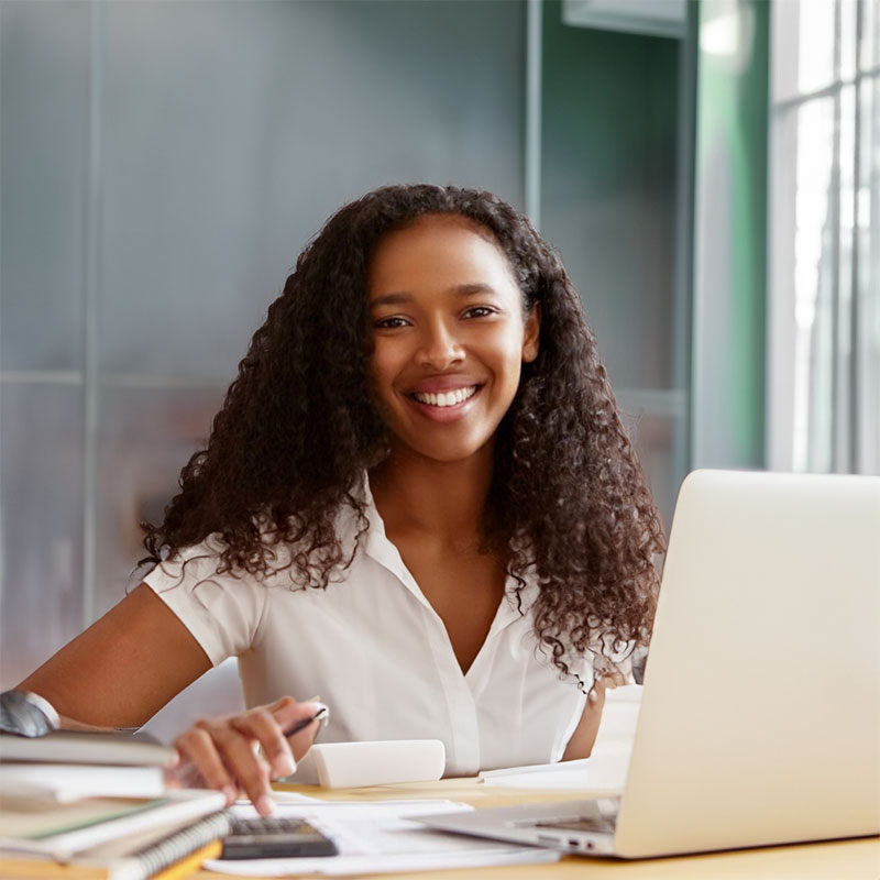 Young Kenyan accountant, sitting at desk. 